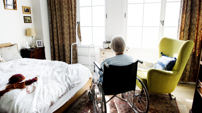 Senior Woman Sitting On The Wheelchair Alone